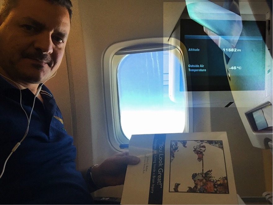 Dr. Ammar Hadi with a copy of 'You Look Great!' at 11,582 meters